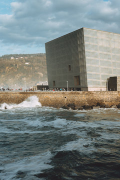 Stormy waves crashing urban waterfront