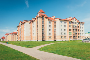 Fototapeta premium Residential buildings with balconies in the city, urban development of apartment houses. Ostrovets, Belarus