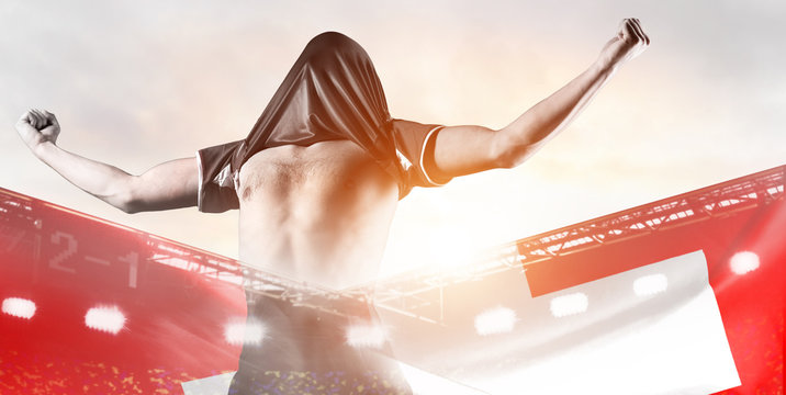 Switzerland national team. Double exposure photo of stadium and soccer or football player celebrating goal with his jersey on head