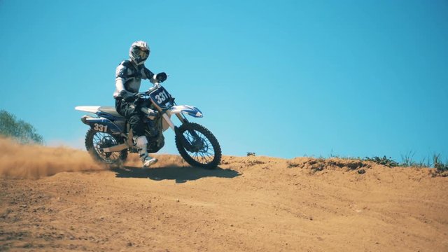 Slow motion of a rider on his autobike showing a gesture