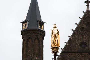 Fototapeta na wymiar Golden Statue and Tower in The Hague, Holland, The Netherlands