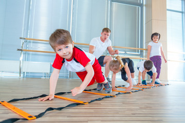 Happy sporty children in gym. Kids exercises