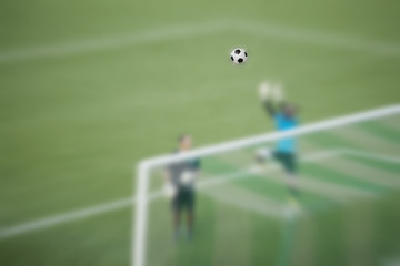 Football is with the players blurred.
