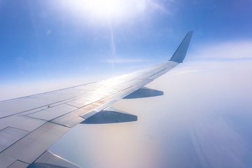 view from the airplane window, ocean blue, sunny day. Vacation concept
