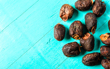 Dried persimmon - healthy raw dessert on a blue wooden background