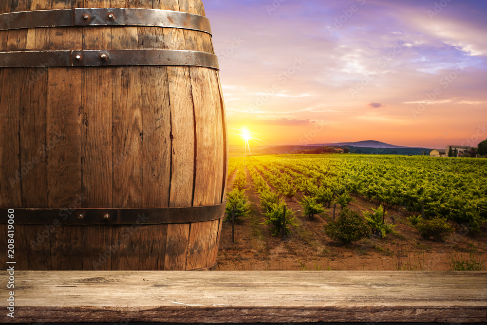 Wall mural Red wine with barrel on vineyard in green Tuscany, Italy