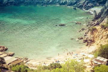 Obraz premium Ibiza, Spain, August 27, 2017: Ibiza natural beach view with some tourists during summer.