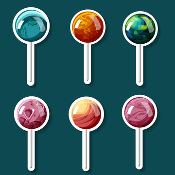 Colorful lollipops in shape of planets isolated on blue.