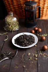 black tea welding on a platter on a dark wooden background