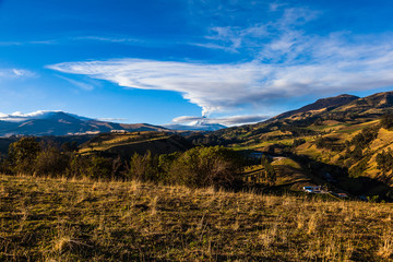 Andean landscape in the morning and the erupting Cotopaxi volcano.