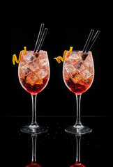 Spritz cocktails. Cold cocktail typical at Italian aperitivo or apericena on black background.