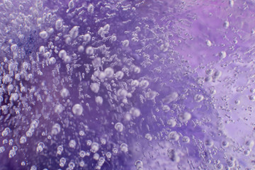 Airy delicate bubbles flowing through ice with purple colors underneath 11