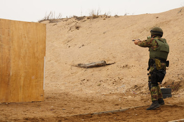 Soldiers with weapons standing on the position