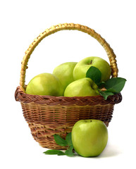 Basket of apples on a white background. Juicy green apples with leaves. Healthy eating. Gardening.
