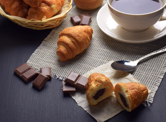 Fresh croissants and a cup of hot tea / coffee. Breakfast. Homemade croissants with chocolate.