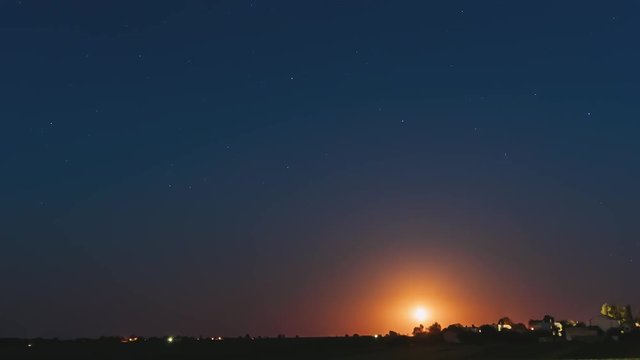 Time Lapse Time-lapse Timelapse Of Moonrise Above Belarusian Village In Eastern Europe. Belarusian House In Village Or Countryside Of Belarus In Summer Starry Night