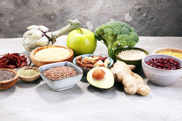 superfood concept on stone table with avocado, goji and nuts and seeds.