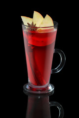 Cup of apple and cherry tea with cinnamon stick isolated on balck