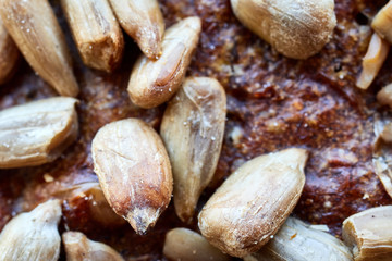 Close up picture of a whole wheat bread crust with sunflower seeds, selective focus.