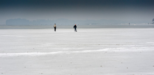 Two skaters on the ice of lake constance