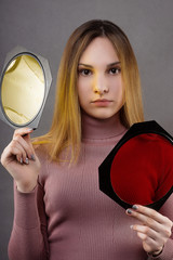Young model playing with color filters for flashes in the Studio