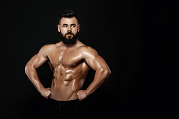 Fototapeta na wymiar strong bodybuilder posing in studio