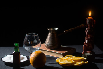 Still life hot cocktail of gin in the dark by candlelight