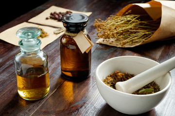 apothecary vintage set of bottles, herbs and mortar