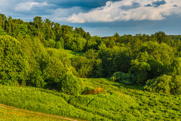 Evening countryside landscape - hills, trees and footpath
