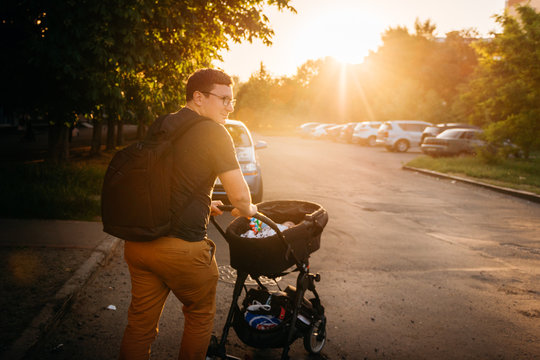 Father Dad With Newborn Pram Stroller Outside During Summer Evening Sunset In City Streets