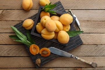 Apricots on wooden board, top view
