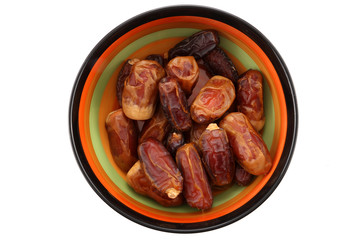Bowl of pitted dates isolated on white background, top view