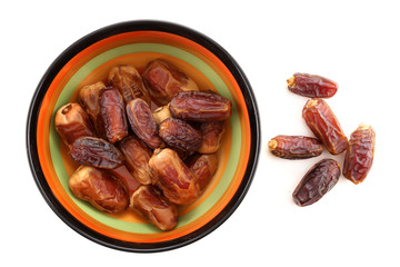 Bowl of pitted dates isolated on white background, top view
