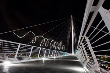 Beautiful white bridge with ice lighting on the background of the night sky