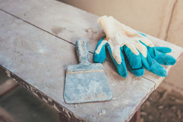 Blue construction gloves and spatula.