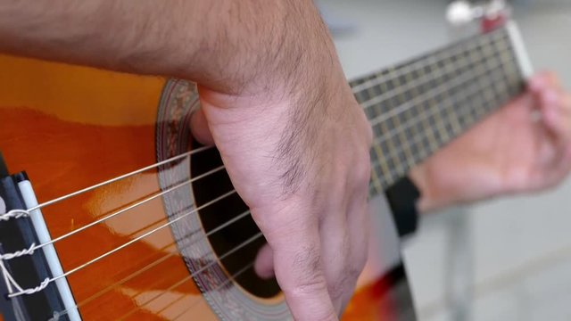 Video guitar playing close fingers and strings,a musician plays a solo guitar,
