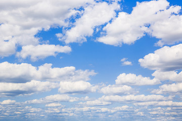 Blue sky with white puffy clouds. Clouds in the blue sky.