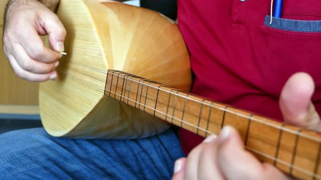 Man playing Turkish saz.(bağlama)Turkish saz of the musical instrument,


