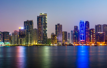 Fototapeta na wymiar Sharjah waterfront cityscape in UAE at blue hour