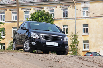 black car parked on the edge of the slope