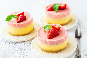 Delicious homemade mango strawberry cheesecake white background Copy space Selective focus.