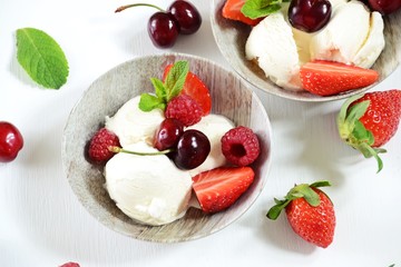 Vanilla ice cream with berries isolated. Ice cream bowl with cherry, raspberry and strawberry