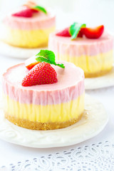 Delicious layred strawberry and mango cheesecake white background Copy space Selective focus.