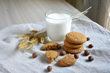 milk, oatmeal cookies and nuts on the table