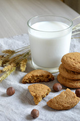 milk, oatmeal cookies and nuts on the table