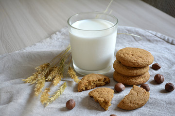 milk, oatmeal cookies and nuts on the table