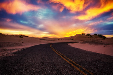 Road into sunset sand dunes