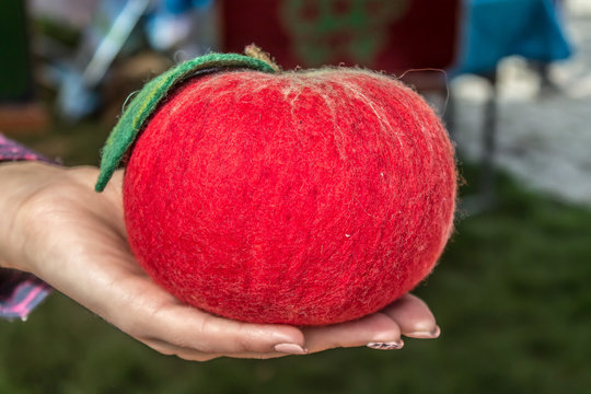 Kazakh products from felt -  Big red apple in hand