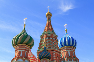 Fototapeta na wymiar Domes of St. Basil's Cathedral on Red square in Moscow against blue sky