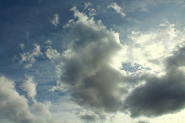 Beautiful blue sky and gray cumulus clouds. Natural appearance. Landscape. Background.